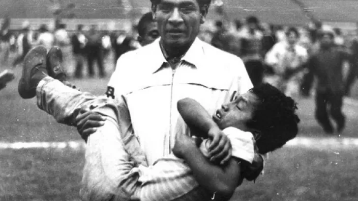 Отец выносит на руках ребенка со стадиона