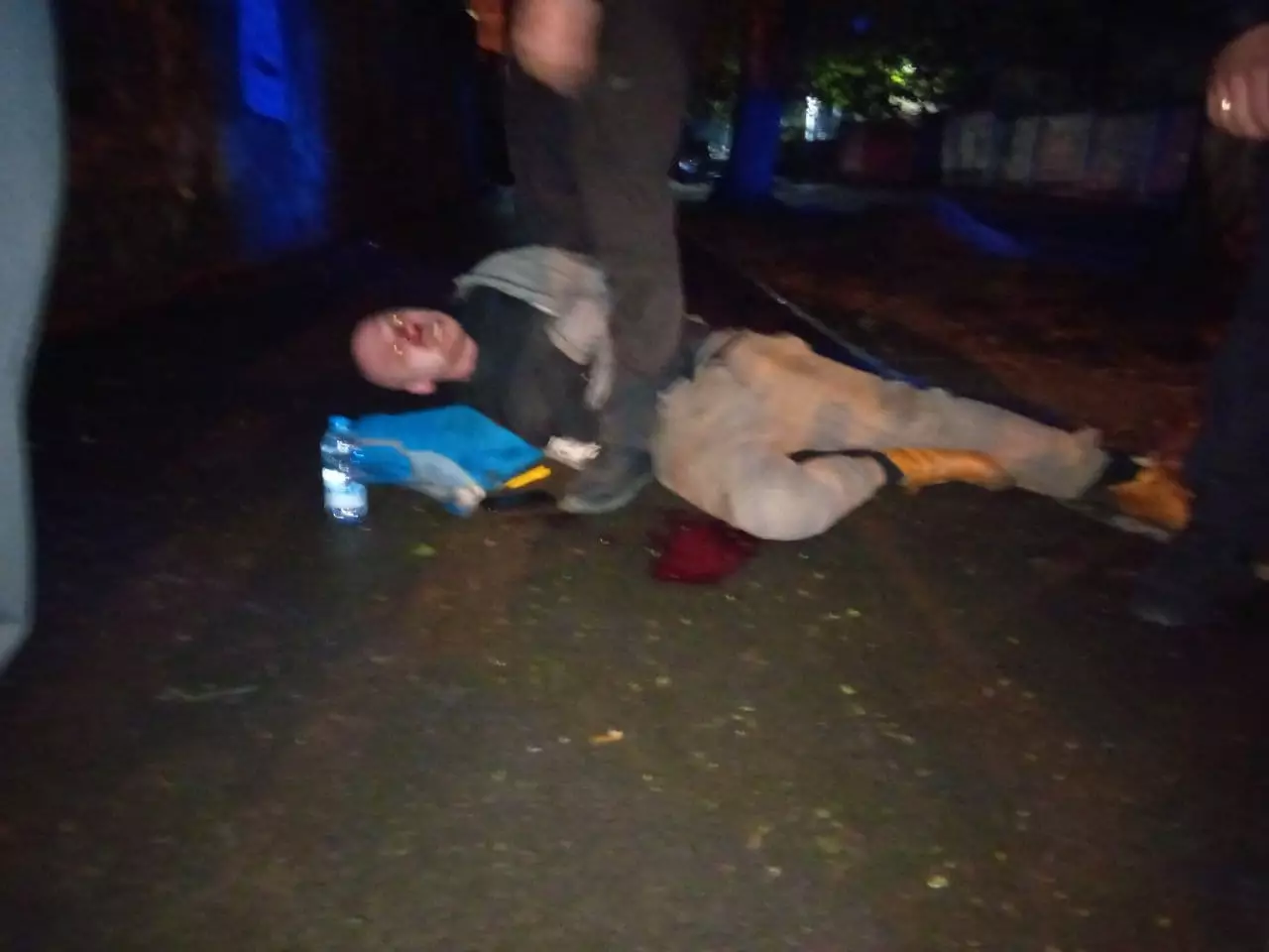 Избитый художник лежит на асфальте. Фото: Facebook