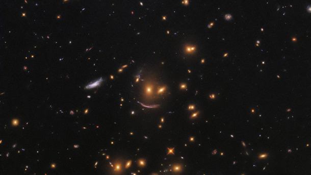 Улыбка вызвана огромной массой галактического кластера SDSS J0952 + 3434. Фото: NASA