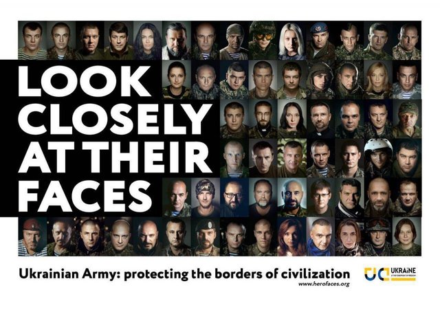 Плакат с фотографиями бойцов и волонтеров был размещен у входа в Арены, где проходил саммит G20